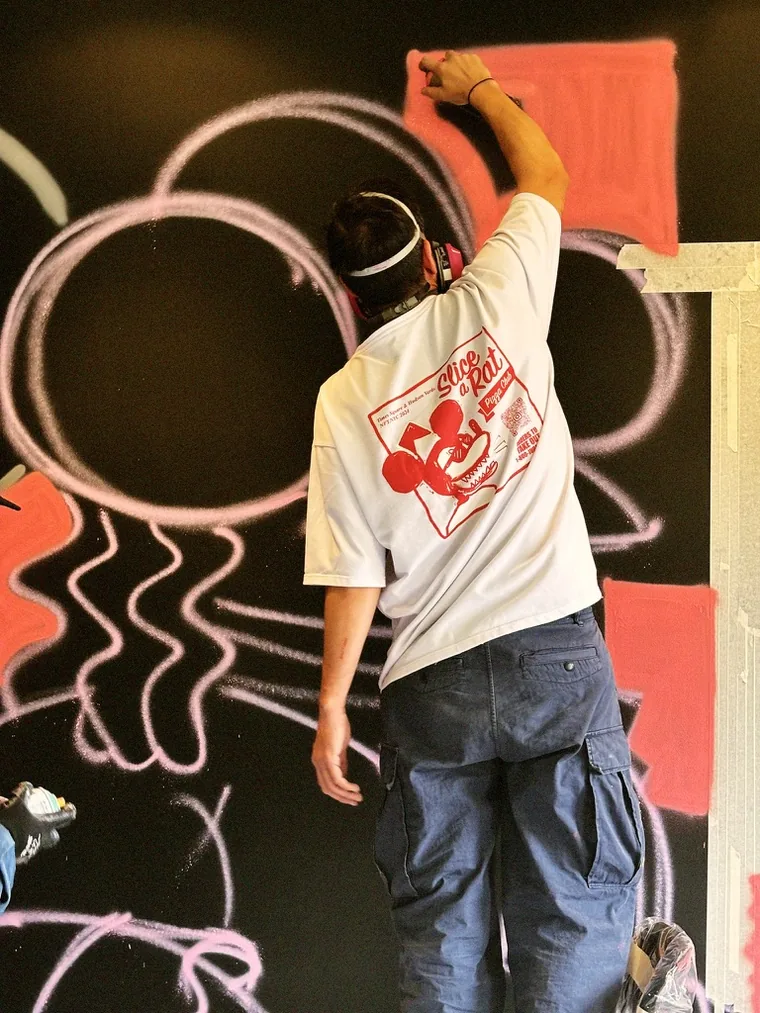 Juan Salazar painting a mural, Bogotá